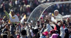 Pope Francis waves to the crowd, aboard the popemobile in Mexico City's main square, the Zocalo, Saturday, Feb. 13, 2016. Pope Francis kicks off his first trip to Mexico on Saturday with speeches to the country's political and ecclesial elites. The pontiff's five-day visit will include a very personal prayer at the Virgin of Guadalupe shrine. (AP Photo/Moises Castillo)